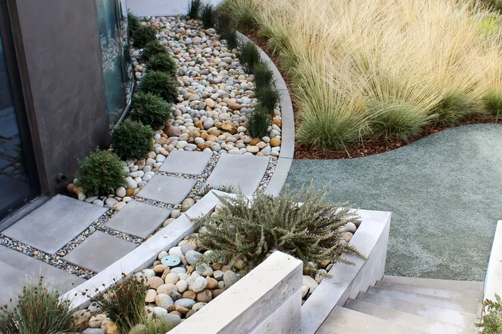 Poured pads, river rock and ornamental grass